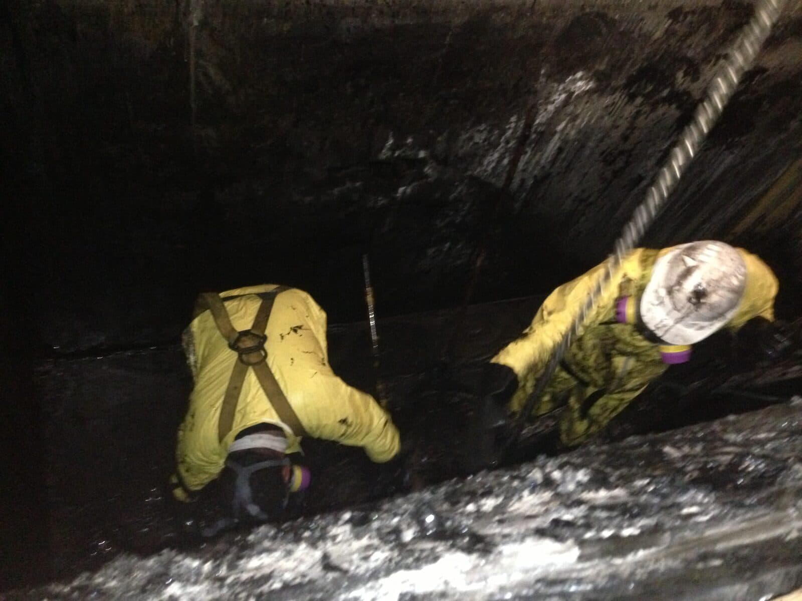 Cowart crew in PPE performing confined-space chemical cleaning inside a process vessel