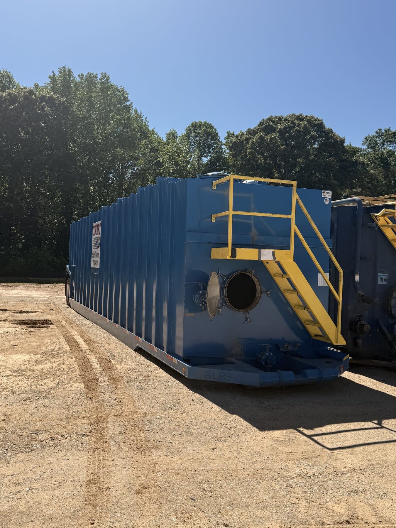 Cowart 21,000-gallon portable frac tank with yellow safety steps and manway access