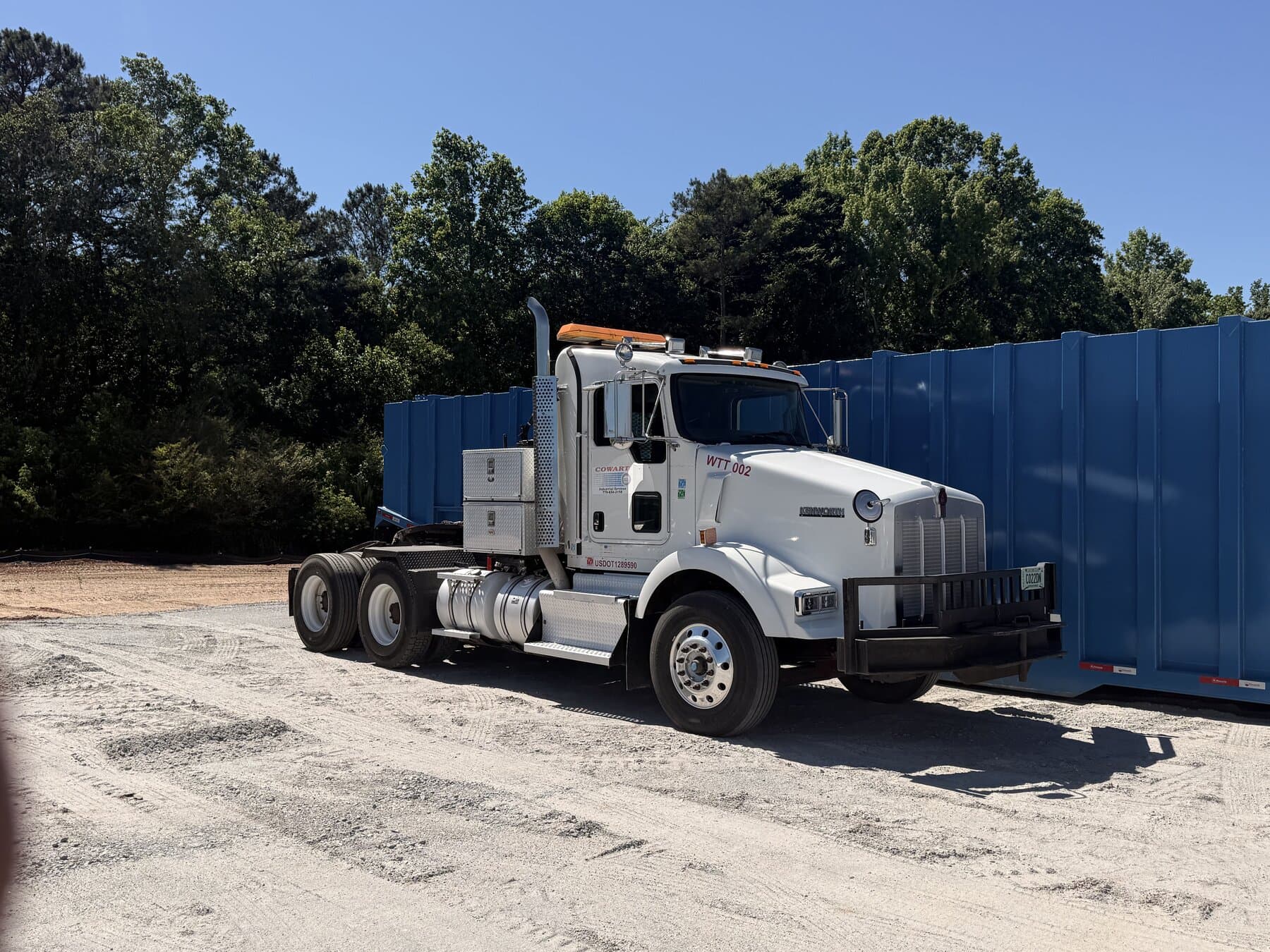 Cowart Kenworth tractor staged with blue waste containers
